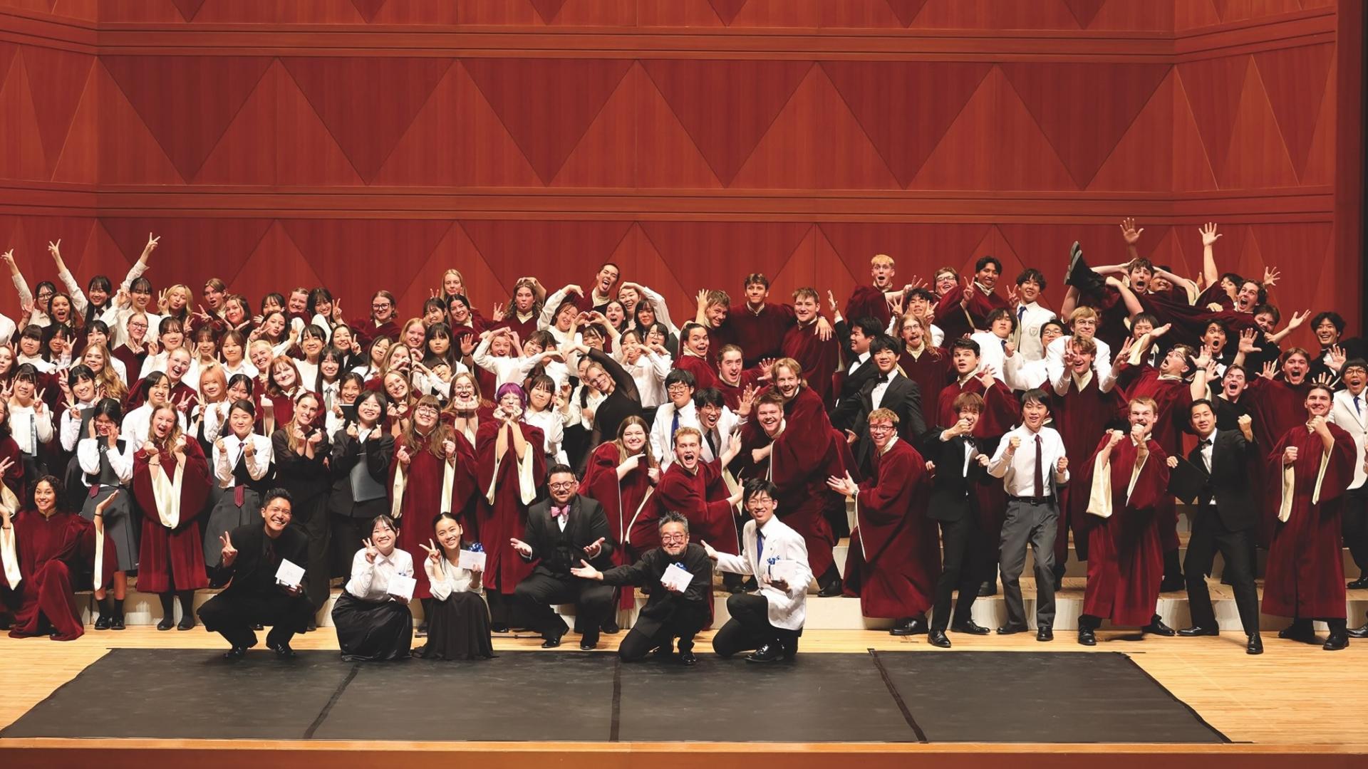 A large group of choir students from the U.S. and Japan mug for the camera. 