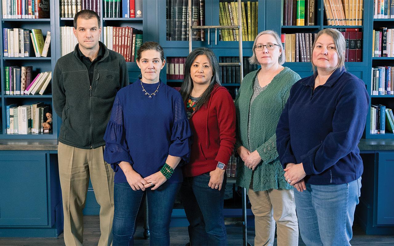 professors standing in front of a wall of books, Dwight Stoll, Betsy Byers, Yurie Hong, Valerie Walker, and Kate Knutson 