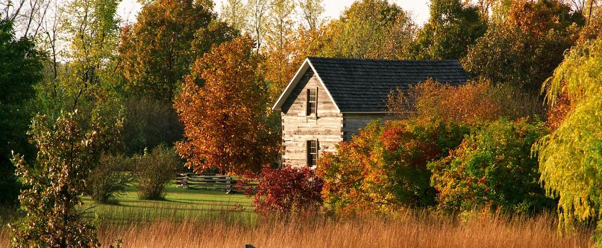 A contemporary fall scene with an 1800s cabin. 
