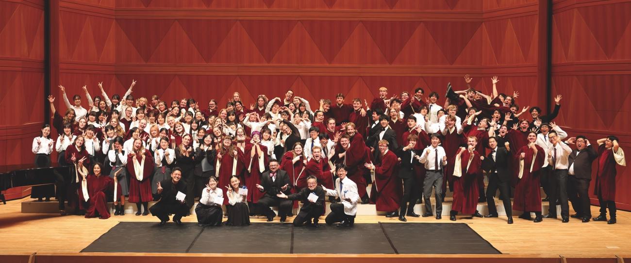 A large group of choir students from the U.S. and Japan mug for the camera. 