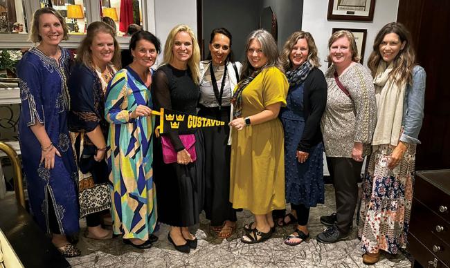 Nine ladies in a row with a Gustavus Adolphus College pendant. 