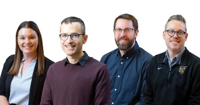 Four professors smile for the camera.
