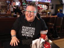 Pictured is Jillian Hiscock sitting in her bar laughing.