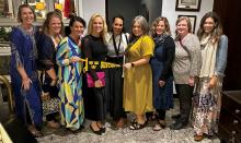 Nine ladies in a row with a Gustavus Adolphus College pendant. 