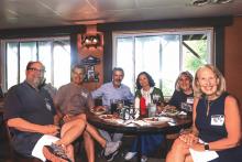 A group of adults smile for the camera. 